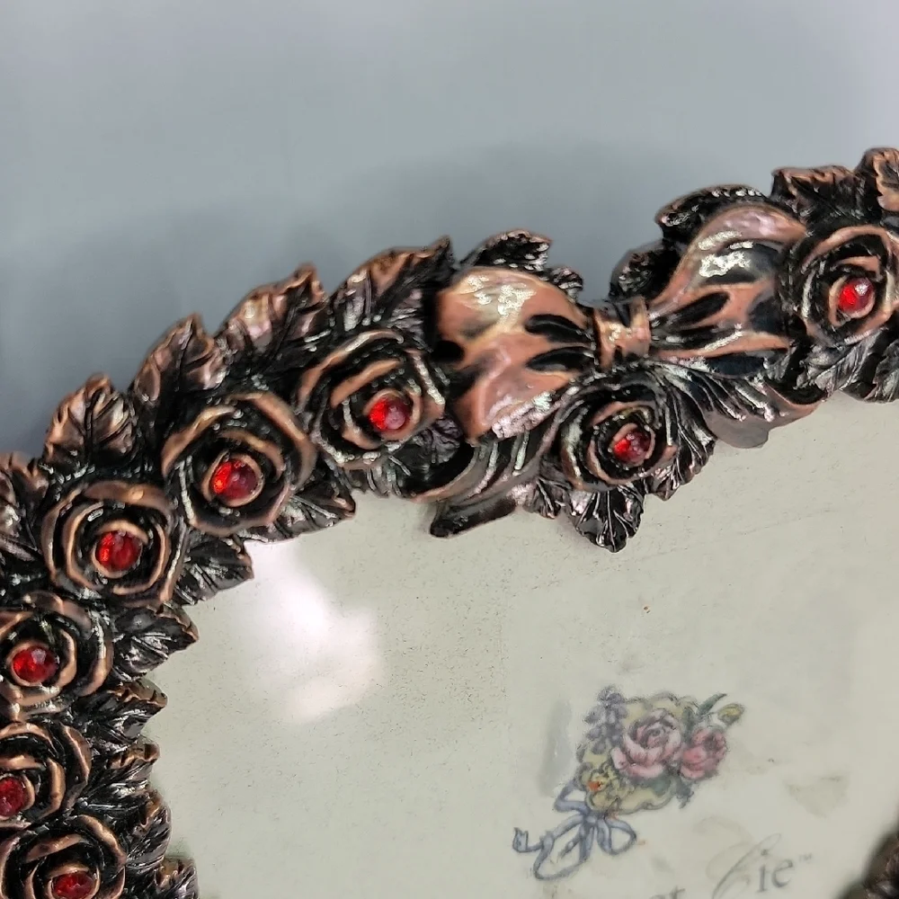 Heart-Shaped Bronze Frame with Red Accents